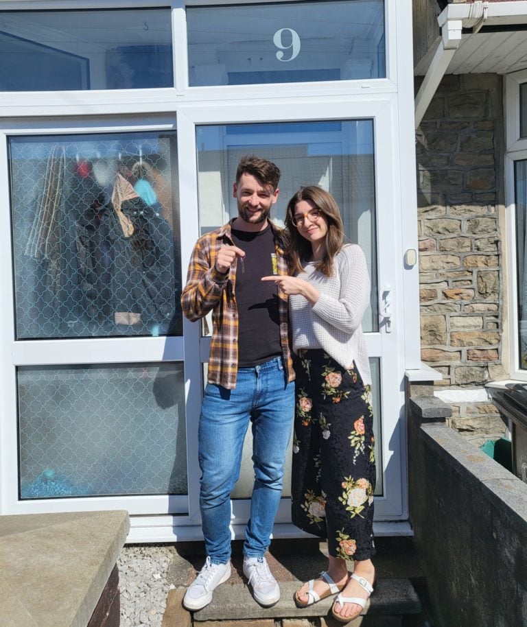 Marcus outside of his house with his partner holding keys