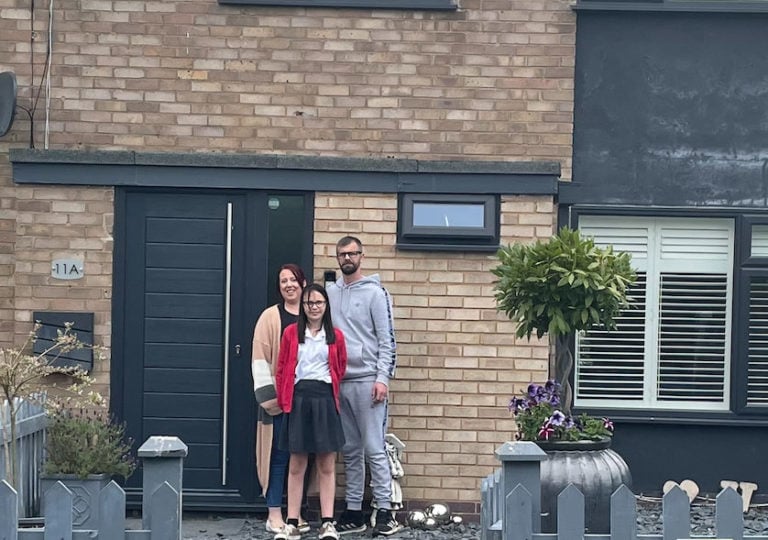 photo of Kerry Eaton and her family outside their home